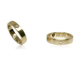 Minimal 14k yellow gold wedding ring with diamond